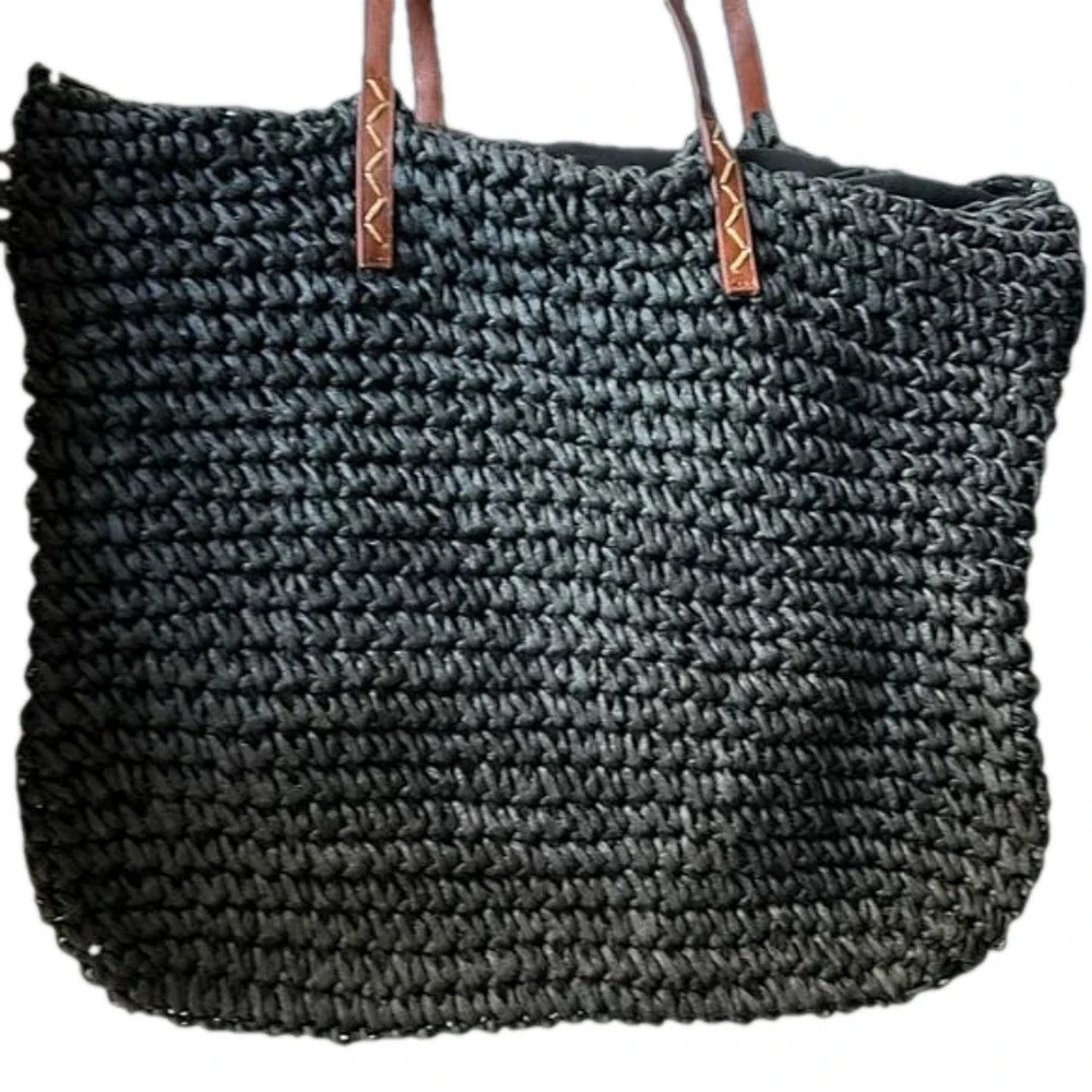 Kenneth Cole straw bag in back with tan straps